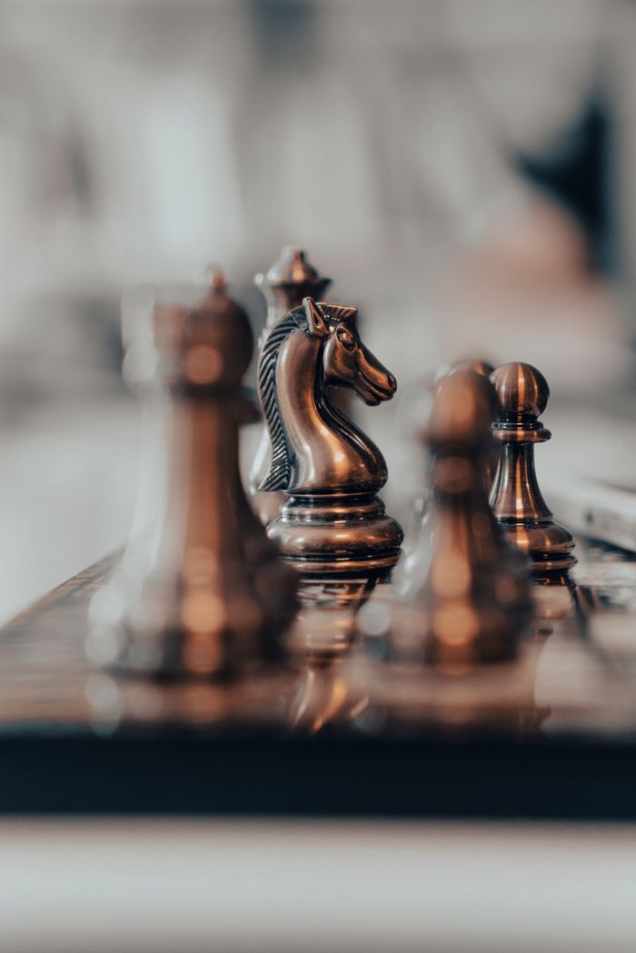 services-01 Artistic close-up of chess pieces, highlighting a knight in focus. Perfect for strategic planning themes.